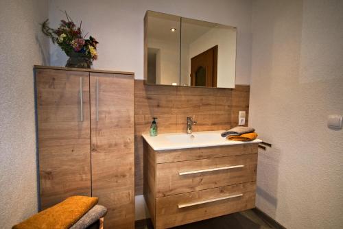 a bathroom with a sink and a mirror at Ferienhaus Gapp in Elmen