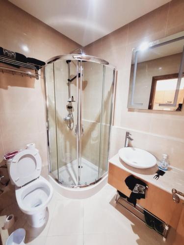 a bathroom with a shower and a toilet and a sink at Marina golf studio in Asilah
