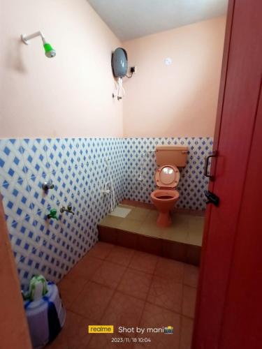a bathroom with a toilet and a shower in it at THIRUNALLAR S A RESIDENCY in Thirunallar