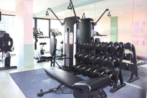 a gym with lots of treadmills and machines at The Quarter Ratchathewi by UHG in Bangkok