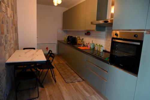 a small kitchen with a table and a microwave at Suite Vittoria in Ortona
