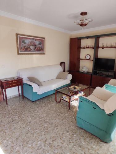 a living room with two chairs and a couch at Piso Vélez Málaga in Vélez-Málaga