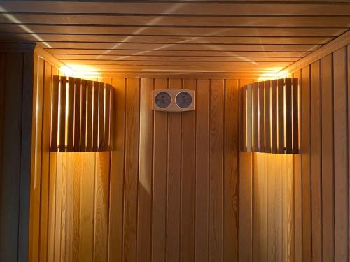 a sauna with two lights on a wooden wall at Rose 5 in Alanya