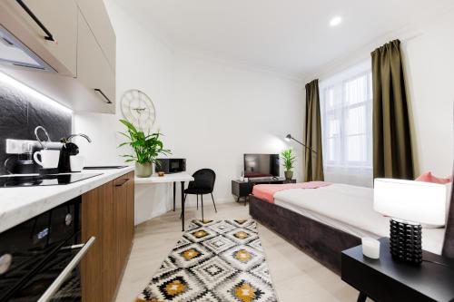a studio apartment with a bed and a kitchen at RIGAAPARTMENT ELIZABETES 22 Self-Service Aparthotel in Rīga