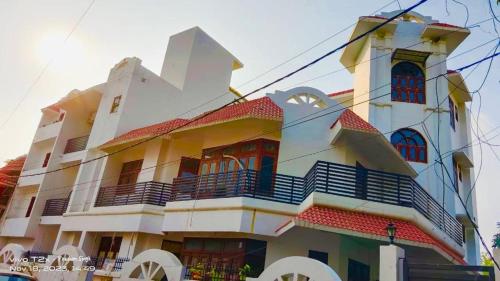 a large building with a clock on top of it at Mauji's Villa Hotel & Guest House in Prayagraj