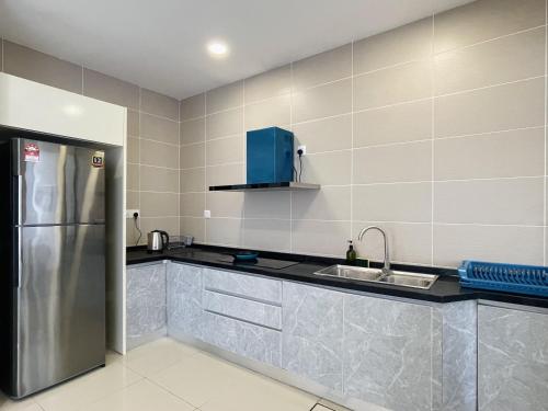 a kitchen with a refrigerator and a sink at D'pristine by Antlerzone in Johor Bahru