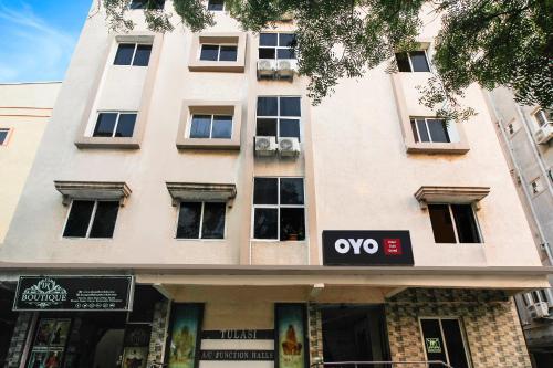 a building with a qo sign in front of it at Super OYO Anuguna Tulasi Grand Near JNTU University Hyderabad in Kukatpalli