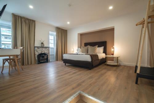 a large bedroom with a bed and a fireplace at D'Ávila Peixinho 180 in Aveiro