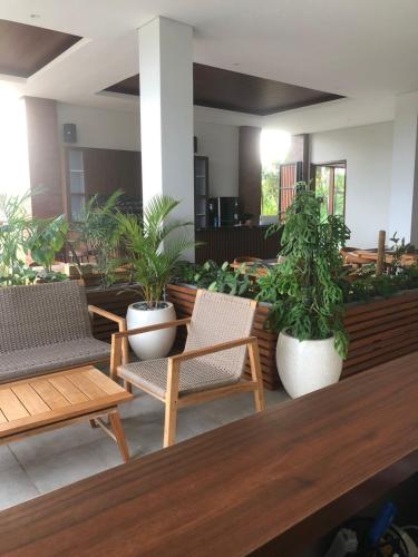 a patio with chairs and potted plants at Mesari Villa in Keramas