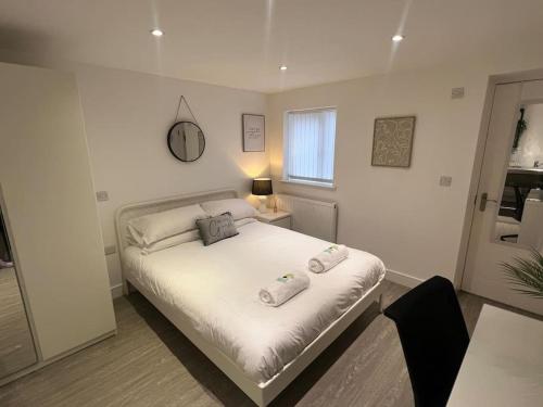 a bedroom with a bed with two pillows on it at 2 Studio flat, 50m from Airbus in Bristol