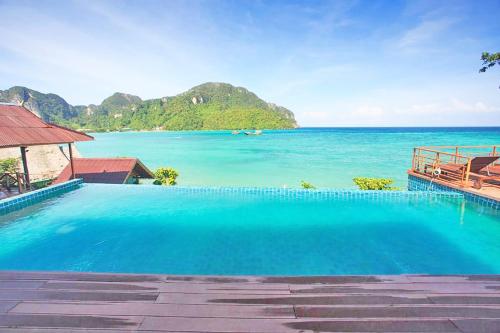 a swimming pool with a view of the ocean at The Cobble Beach Hotel- Phi Phi Island in Phi Phi Don