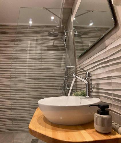 a bathroom with a white sink and a mirror at Μούσες in Kalavrita