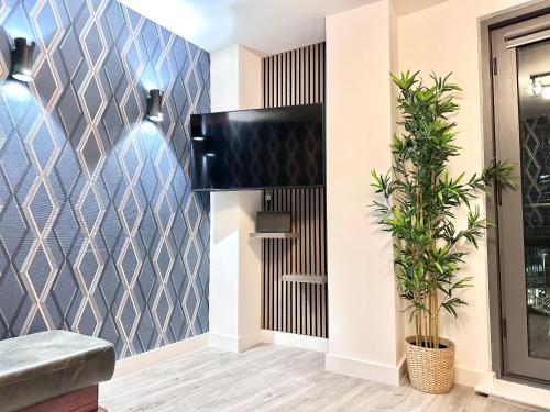a room with a blue tiled wall at City centre, Top floor apartment, Two balconies in Manchester