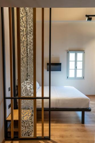 a bedroom with a bed with a glass wall at Kraka Apartments in Leonidion