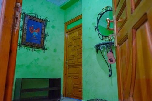 a room with a door and a picture on the wall at CASA RAYAN in Chefchaouene