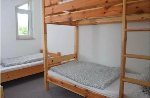 two bunk beds in a room with a window at Ferienhaus an der Westernstadt in Eging in Eging