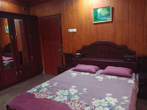 a bedroom with a bed with two pillows on it at Pournami Home Stay in Trichūr