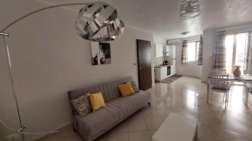 a living room with a couch and a dining room at Vespucci Holiday in Casteldaccia