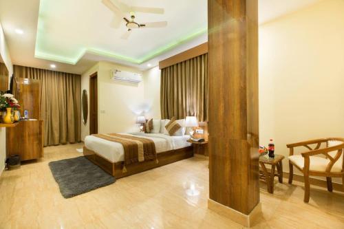 a hotel room with a bed and a couch at OPO Viva Palace,Free Airport Pick-up in New Delhi