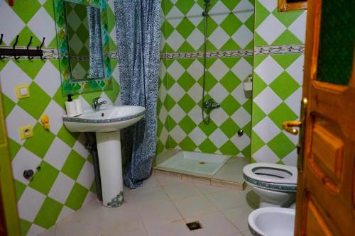 a bathroom with a sink and a toilet at CASA RAYAN in Chefchaouene