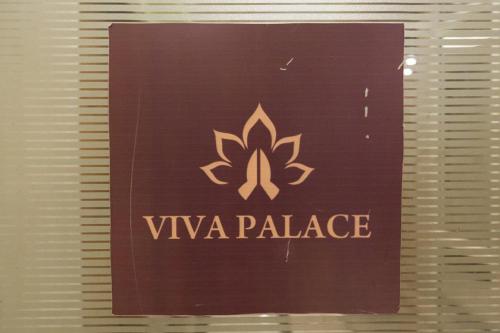 a sign for a vasy palace on a window at OPO Viva Palace,Free Airport Pick-up in New Delhi