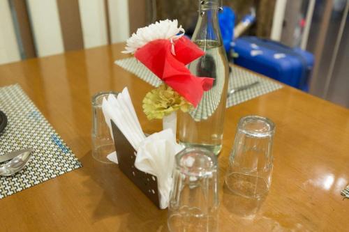 a vase with flowers in it on a table at OPO Viva Palace,Free Airport Pick-up in New Delhi