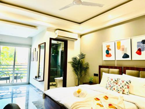 a bedroom with a bed and a balcony at BluO Studio1 DLF CyberCity - Balcony, Gym TT, Lift in Gurgaon