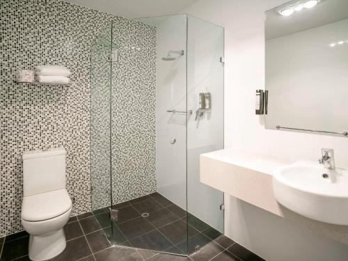 a bathroom with a toilet and a sink and a shower at Adelaide Rockford in Adelaide