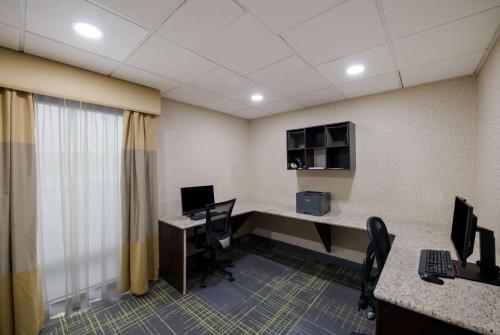 an office with a desk with two computers and chairs at Hampton Inn Marshall in Marshall