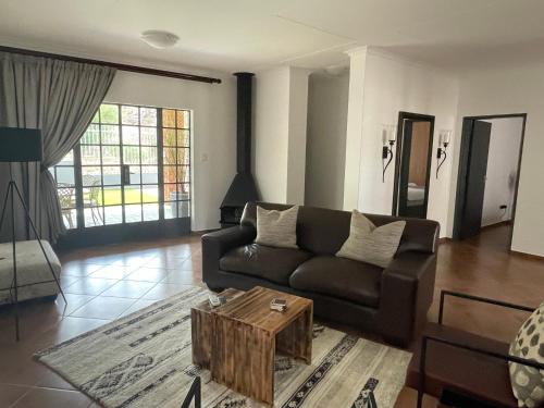 a living room with a couch and a coffee table at City comfort self catering Windhoek in Windhoek