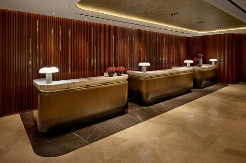 a lobby with a row of stalls in a building at London Hilton on Park Lane in London