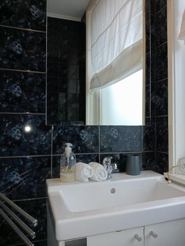 a bathroom with a white sink and a mirror at Studio Slijterij Zandvoort in Zandvoort