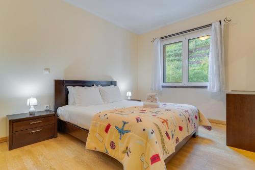 a bedroom with a bed and a window at Isabel Apartment by Holiday Rental Madeira in Ribeira Brava