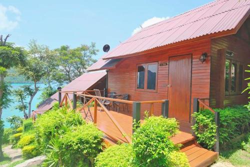 a wooden house with a porch and a deck at The Cobble Beach Hotel- Phi Phi Island in Phi Phi Don