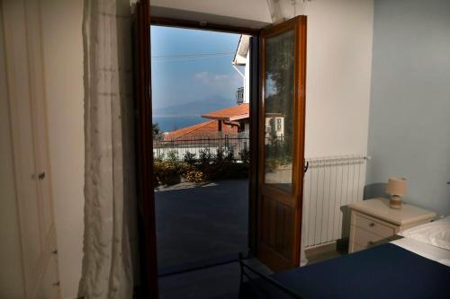 a door to a bedroom with a view of a balcony at Villa Serena in Vico Equense