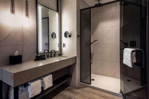 a bathroom with a sink and a shower at Hyatt Centric Charlotte SouthPark in Charlotte