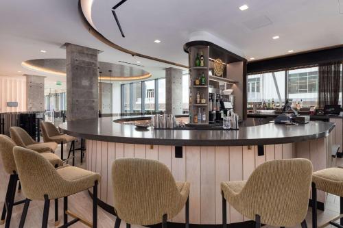 a bar in a restaurant with chairs and tables at Hyatt Centric Charlotte SouthPark in Charlotte