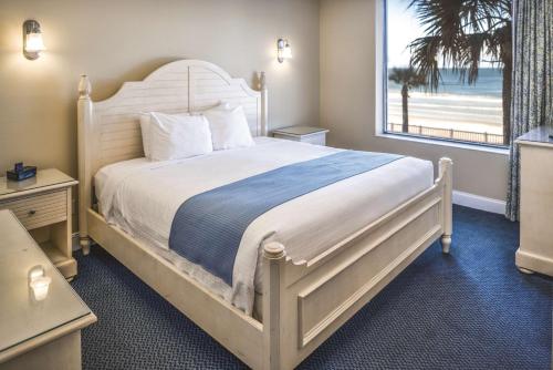 a bedroom with a bed with a view of the beach at Hilton Vacation Club The Cove on Ormond Beach in Ormond Beach