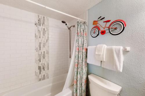 a bathroom with a red bike on the wall at Lei Lani Tower 502 in Orange Beach