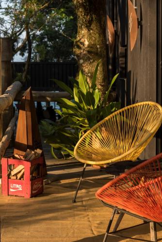 a yellow chair sitting next to a table with boxes at Pousada Vila do Mel in Pontal do Paraná