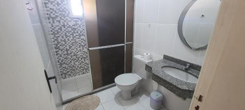a bathroom with a shower and a toilet and a sink at Pousada Pau Brasil in Guapimirim