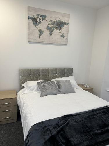 a bedroom with a bed with a map on the wall at Room with King Size Bed and Private En suite Bathroom in the Centre in Watford