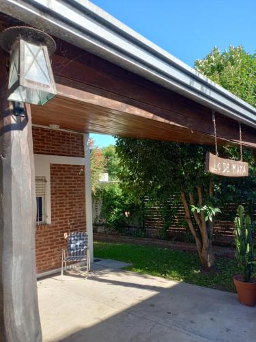 a patio with awning and a sign that reads loewan at LA FATIMA in Gualeguaychú
