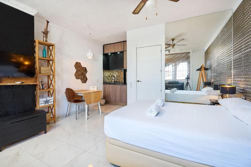 a bedroom with a large bed and a bathroom at Espanhouse Magani in Torrevieja