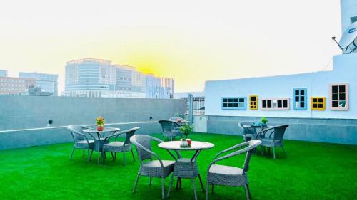 a patio with tables and chairs on a roof at BluO Studio4 DLF Cybercity - Balcony, Gym TT, Lift in Gurgaon