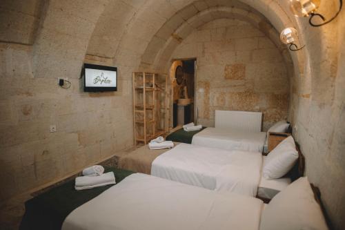 a group of four beds in a room at DAPHNE CAVE HOTEL in Avanos