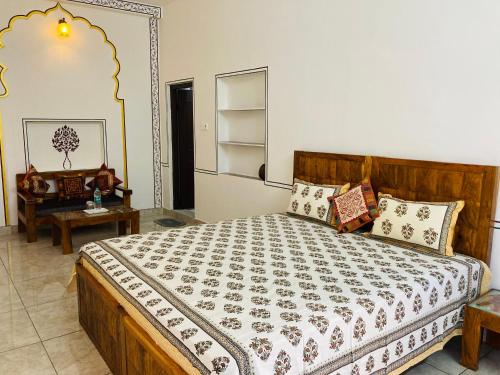 a bedroom with a large bed and a table at Hotel tulsi palace in Pushkar