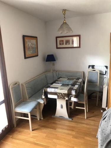 a living room with a couch and a table and chairs at Casa Rincón de Broto in Broto