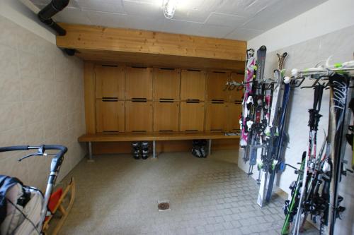 a room with a bunch of skis on a wall at Landwasser in Davos