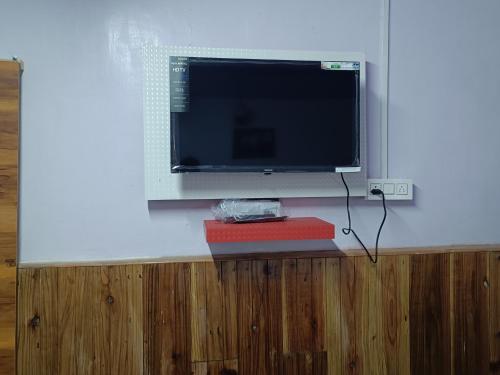 a flat screen tv sitting on top of a wall at KDol Residency in Darjeeling